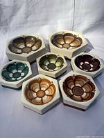 All seven hexagonal dishes showing rosette motifs and size variation