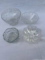 Group shot of all four clear pressed glass bowls