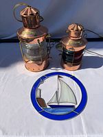 Both copper lanterns and stained glass panel displayed together