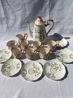 complete 15-piece Braemar demitasse set arranged on cloth
