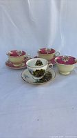 Four teacups and three saucers grouped