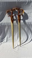 Full view of both wooden swords showing overall design and size