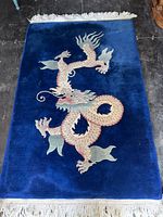 Full view of blue dragon rug