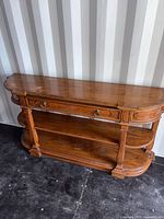 Front view of console table showing overall design, drawer, shelves