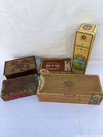 Group shot of all boxes and tins in lot