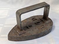 Full view of cast iron sad iron showing handle and base