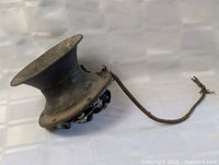 Side view of flared bell automobile horn with attached wire