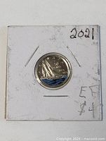 Front of coin in 2×2 holder displaying Bluenose design and blue enamel