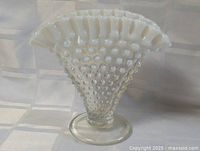 Front view of milk glass hobnail vase showing pattern and clear foot