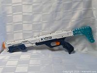 Full right-side view showing entire blaster with folding stock extended
