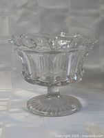 Side view of clear glass pedestal bowl on pedestal foot