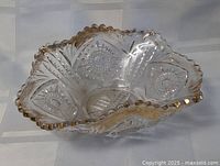 Top angled view showing overall shape, starburst pattern and gold-trimmed scalloped edge