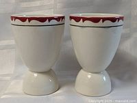 both egg cups front view showing shape and matching decoration
