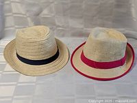 Both straw fedoras side by side showing bands and overall shape
