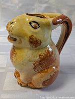 Left-front view of ceramic rabbit pitcher