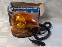 Beacon light and coiled cord staged beside original box