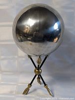 Full view of sphere on arrow stand