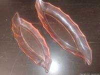 Two pink Depression glass bowls side by side showing size difference