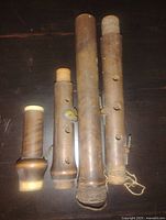 Four wooden sections of the instrument laid flat