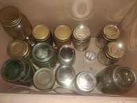 Top view of box showing multiple Mason jars with metal lids