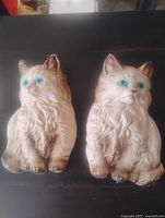 Front view of both chalkware cat plaques