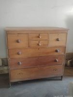 Full front view of antique wooden chest of drawers