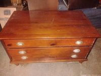 Front view showing two drawers with metal cup pulls