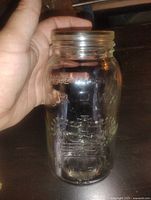 Front view of clear glass Crown mason jar showing embossed crown logo and Made in Canada text