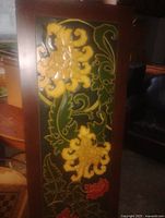Full view of carved painted wooden panel showing floral design