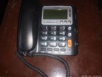 Front view of VTech corded telephone showing handset, keypad and LCD