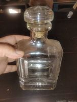 front view showing square glass decanter and stopper