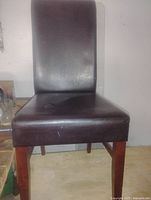 Front view of dark brown faux leather high-back chair with wood legs