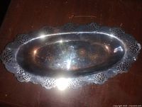 Top view of silver-plated oval platter showing full shape and pierced rim