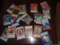 Top-down view of scattered Yu-Gi-Oh cards showing fronts and varied card types