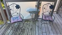 Full view of two chairs and table on deck