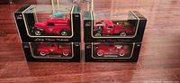 Four Liberty Classics Canadian Tire trucks in boxes, stacked two by two