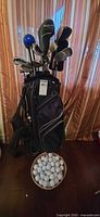 Overall view of golf bag with clubs and basket of balls
