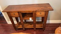 Front view of pine console table showing drawers, cubby and shelf