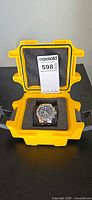 Watch in yellow hard case showing lot