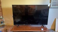Front view of LG 55UJ6200 television on wooden table