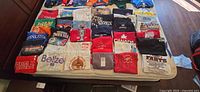Overhead view of entire lot of T-shirts laid out on bed