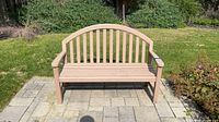 Front view of painted wood slat outdoor bench on patio