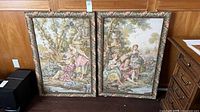 Both framed tapestries standing side by side showing full artwork and frames