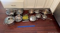 Group shot of all cookware pieces and cookbook