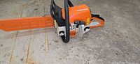 Stihl MS 230 chainsaw with bar scabbard on concrete floor