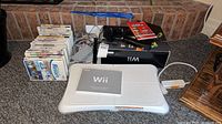 Wii console, balance board, controllers, cables, game cases