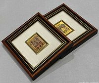 Two framed chromolithograph prints lying side-by-side