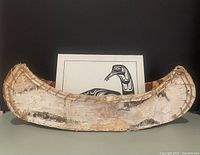 Canoe front view with artwork behind