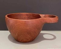 side view of teak kuksa showing handle and grain