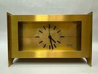 Front view of Stager quartz brass mantle clock showing dial and glass front